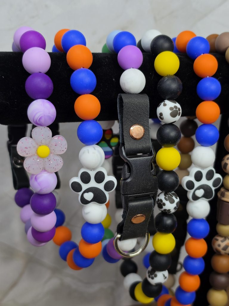 beaded dog colloars on a stand